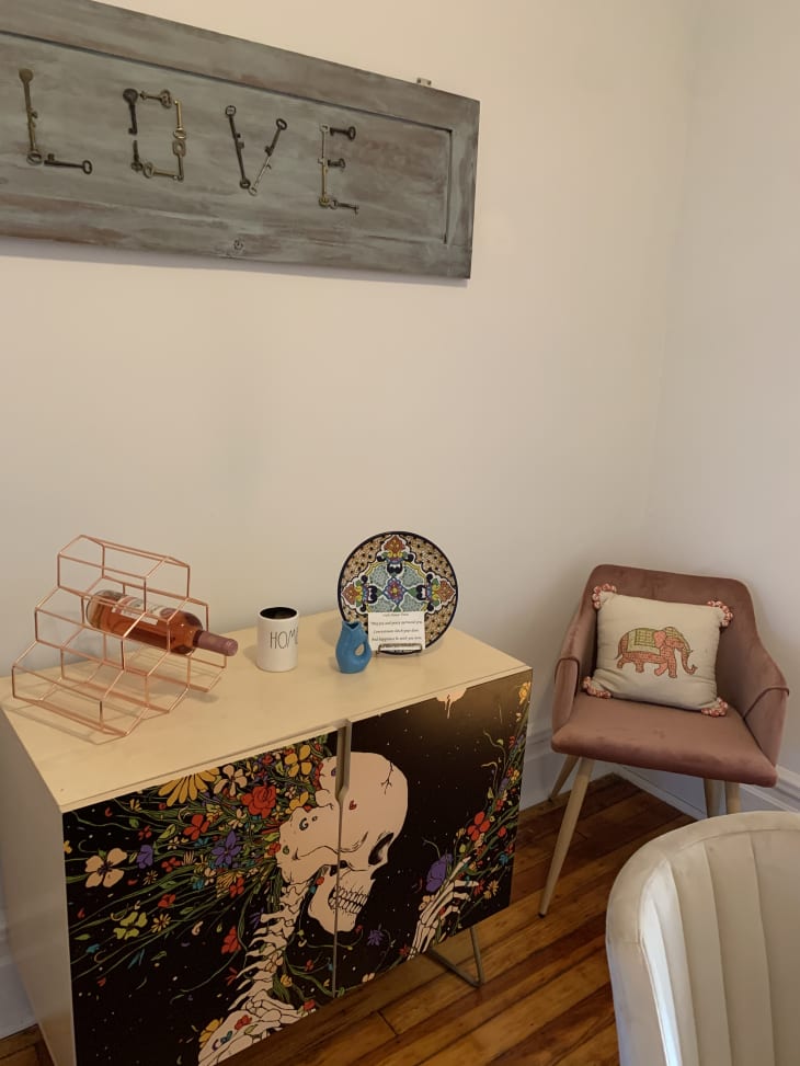 Painted credenza and pink chair in corner