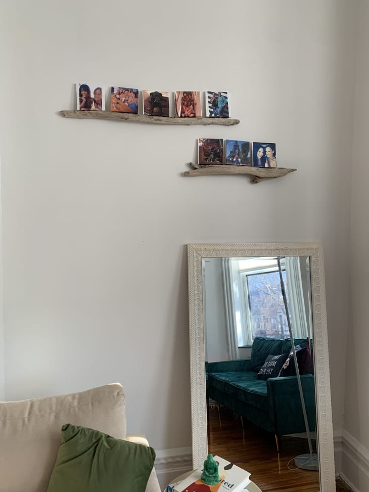 Driftwood shelves and mirror leaning against wall