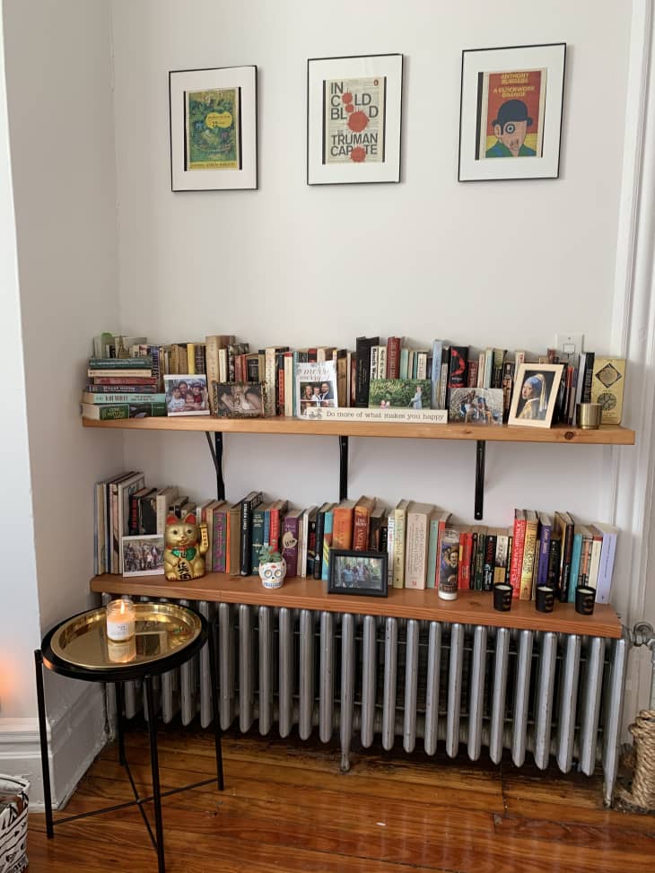 Bookshelves and frames above radiator