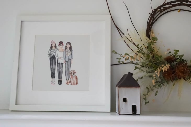 Shelf with illustrated family portrait and wreath