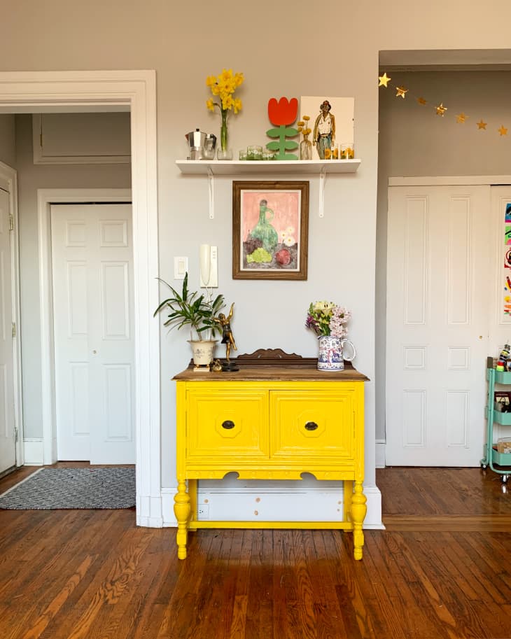 Yellow sideboard beneath shelf