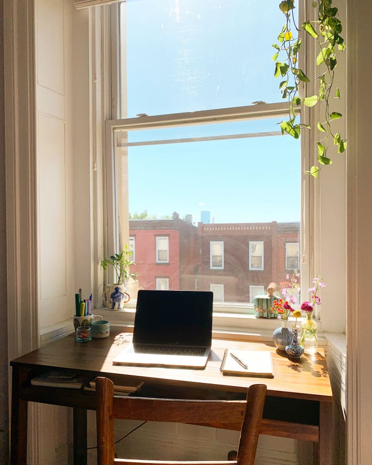 Desk with laptop in front of window