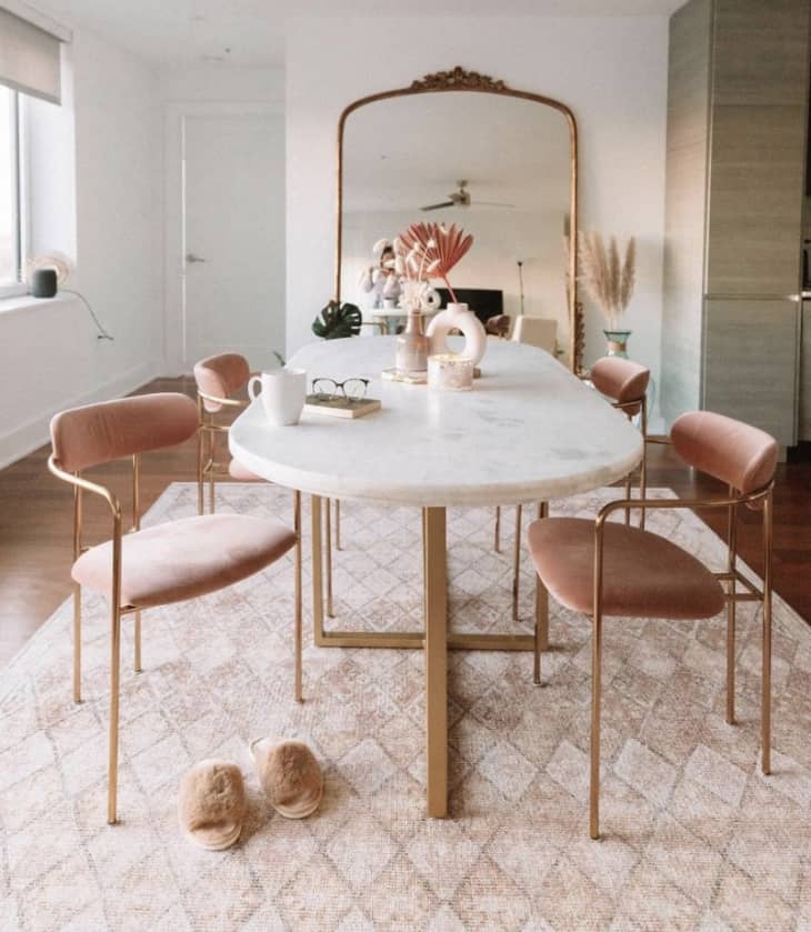 Dining room with marble table and gold and blush accents