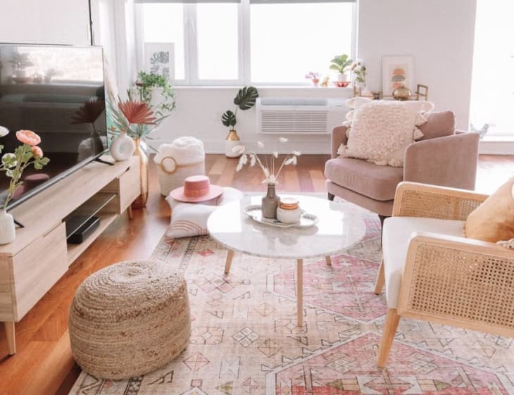 Pink and boho living room with lots of plants and flowers