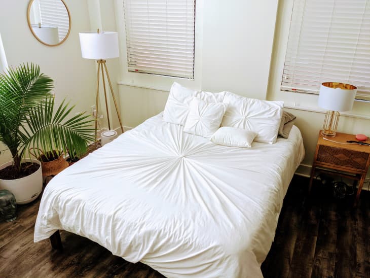 Bed with white rouched linens