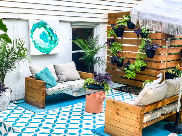 Patio with blue decor and plant wall