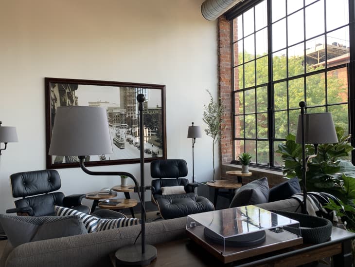 Living room with two black Eames chairs and large windows