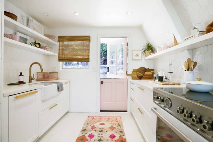Kitchen with white cabinets and pink and neutral accessories