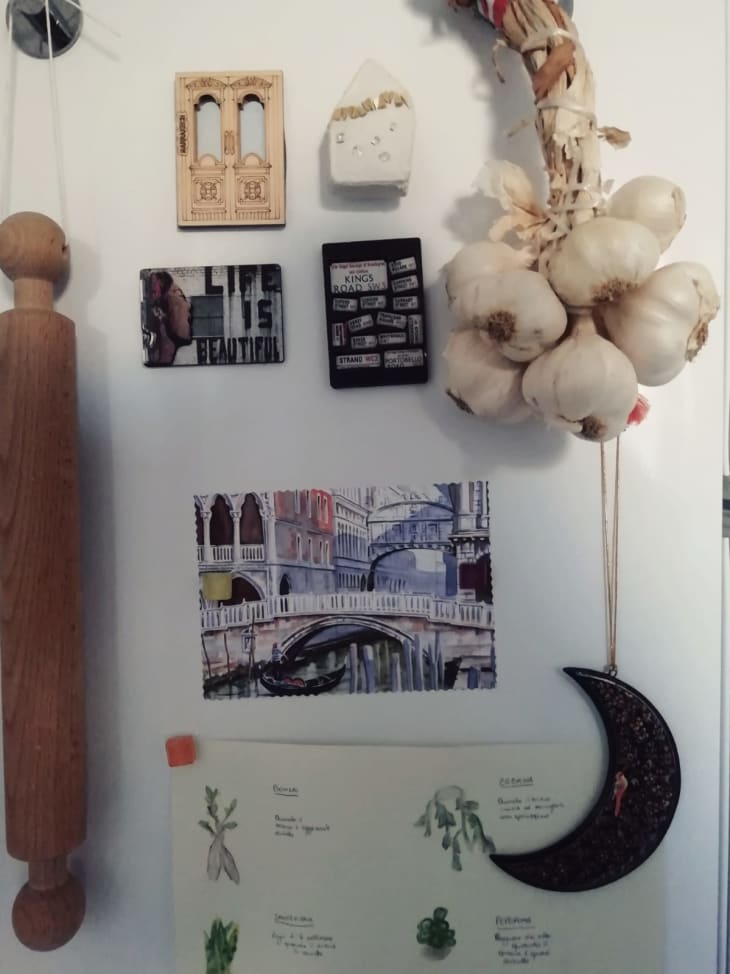 Garlic cloves, rolling pin, and artwork hanging in kitchen