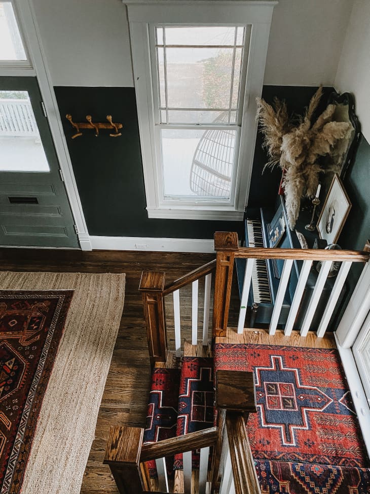 Aerial view of foyer with vintage rugs and earthy color scheme