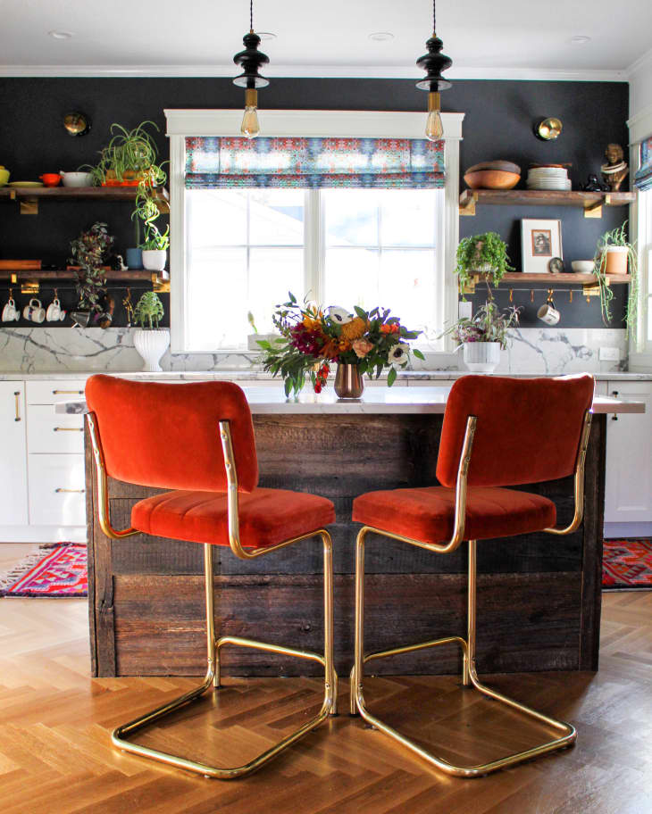 Red velvet stools at island in kitchen