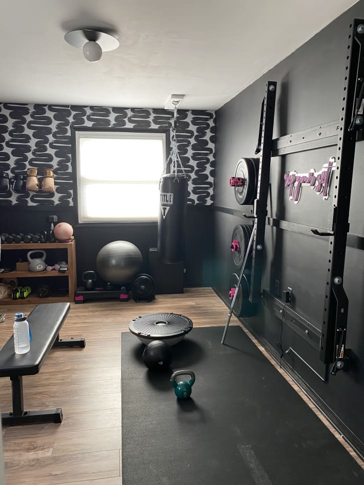 Home gym with black and white squiggly wallpaper
