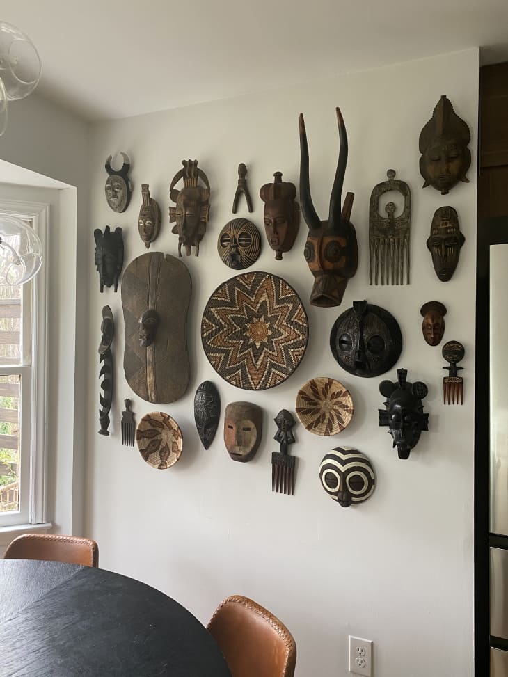 African artwork on wall next to table