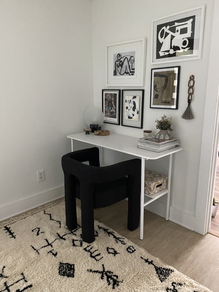 White desk with modern black chair in corner