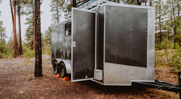 Cargo trailer tiny home outside in woods
