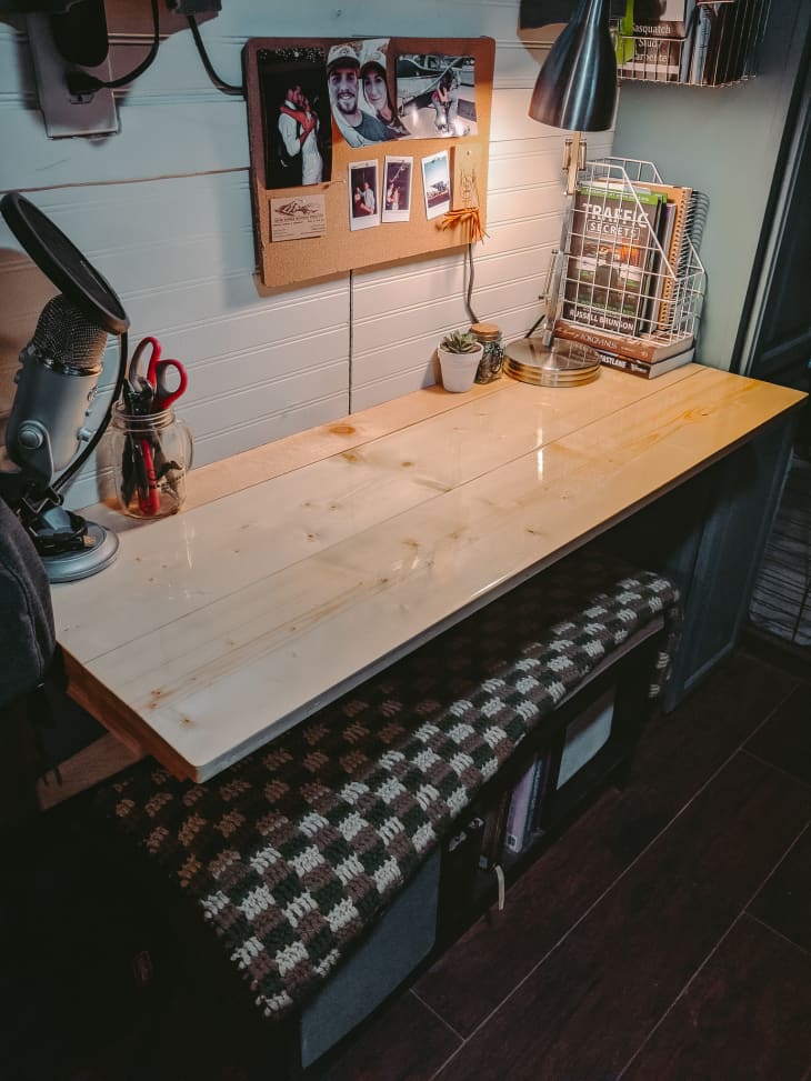 Work table attached to wall with pullout bench underneath
