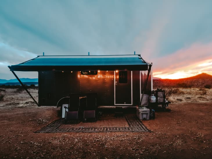 Cargo trailer tiny home outside at sunset
