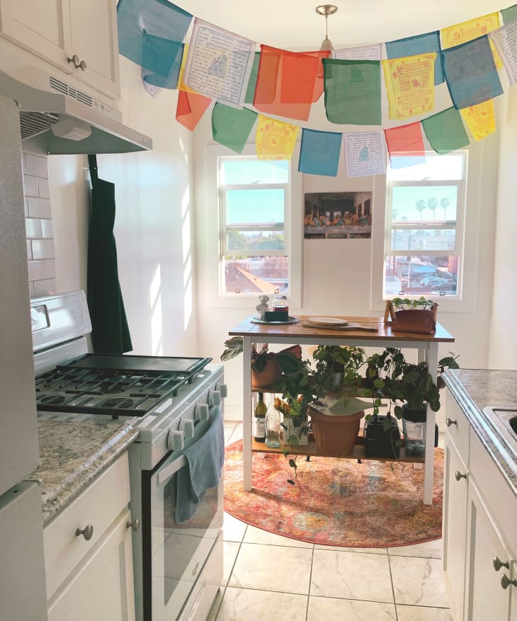 Kitchen with colorful scarves hanging from ceiling