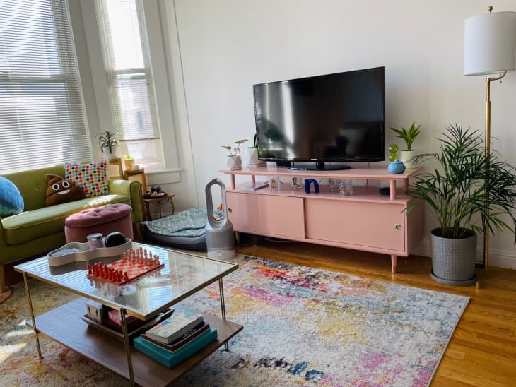 TV on pink cabinet in living room