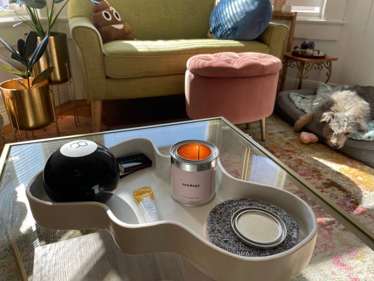 Wavy tray holding Magic 8 Ball and candle on coffee table
