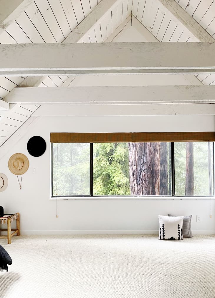 Bright white A-frame room with large window