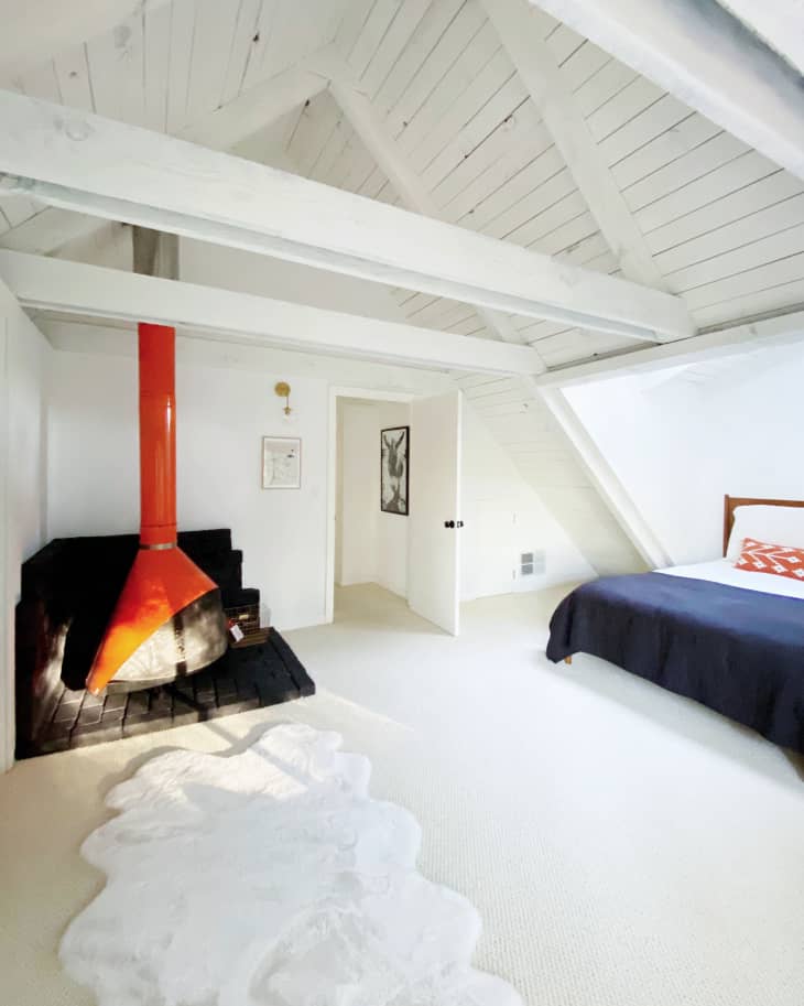 Bedroom with red Malm fireplace in corner