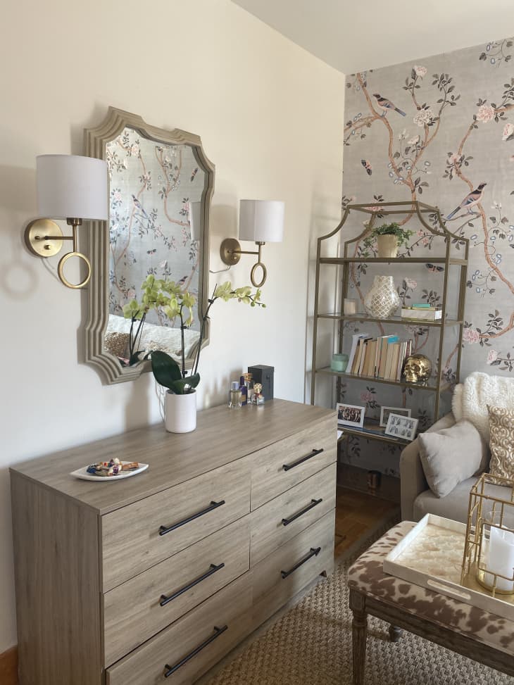 Large mirror and two sconces with shades above dresser