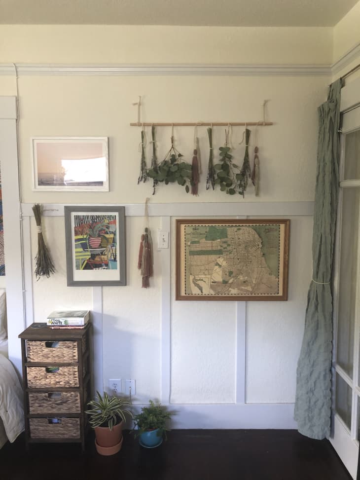Dried greenery and wall art hanging on wall