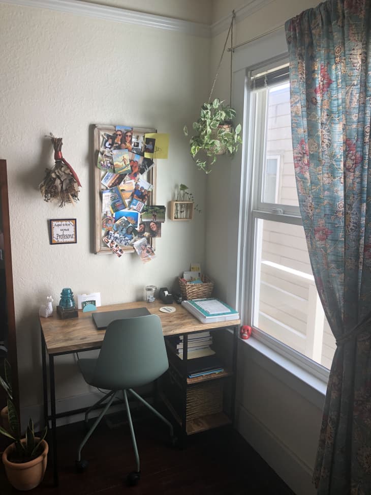 Desk with teal chair next to window