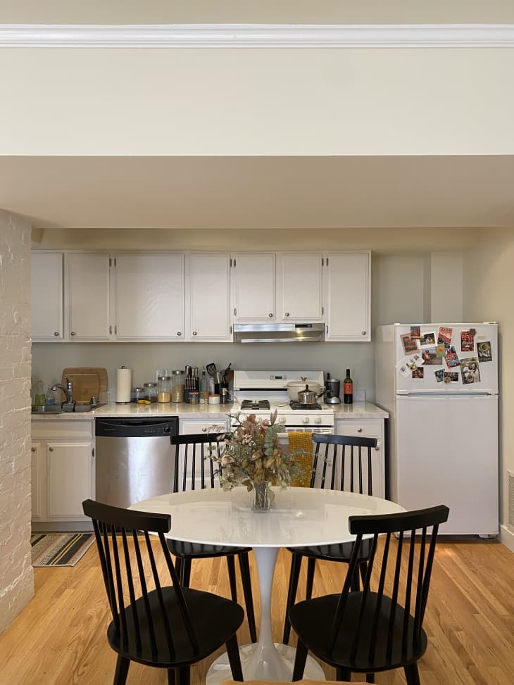 Kitchen with round white table and black spindle chairs