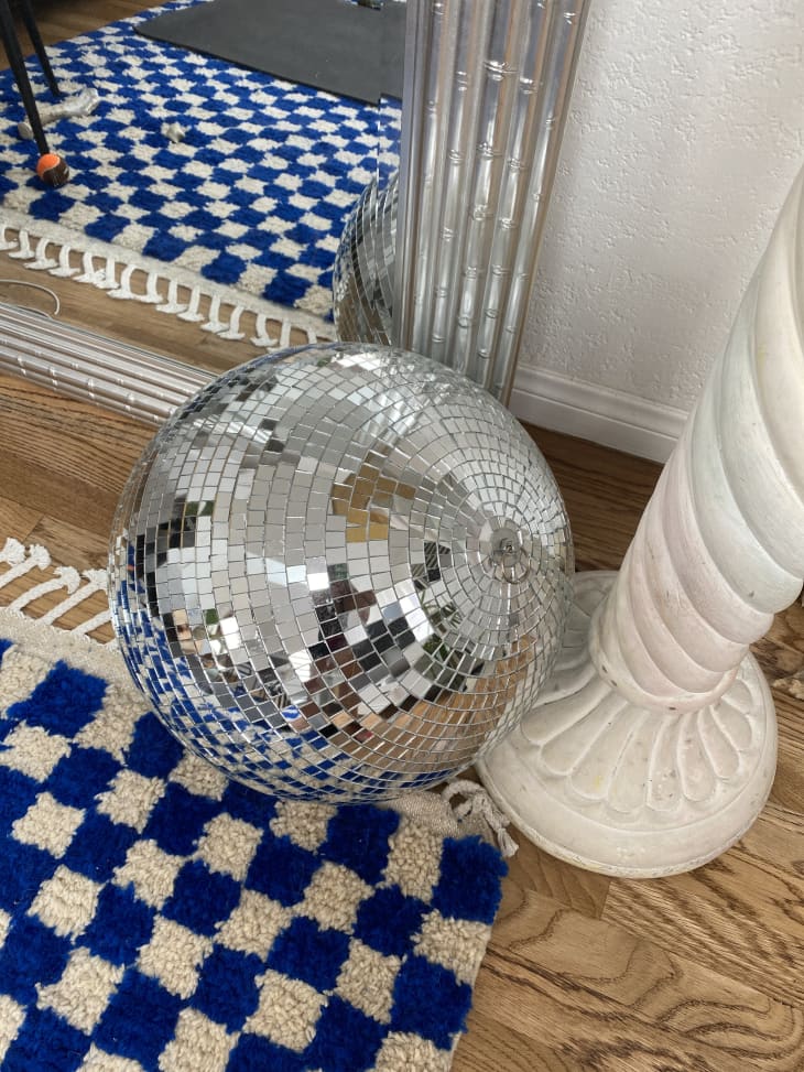 Disco ball on top of blue and white checkerboard rug