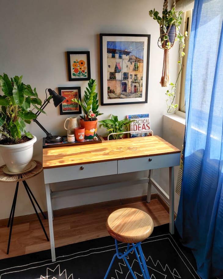 Desk next to window with blue curtain