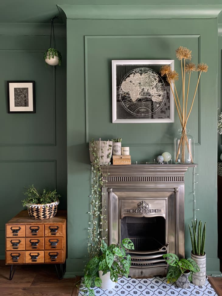 Room with iron fireplace and green walls