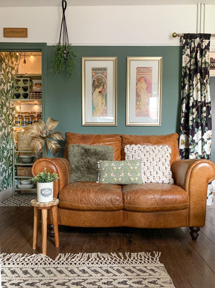 Leather loveseat in room with green walls