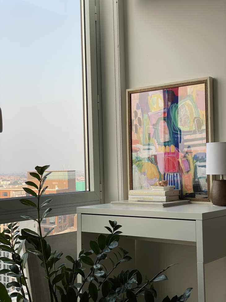 Desk and colorful artwork next to large window