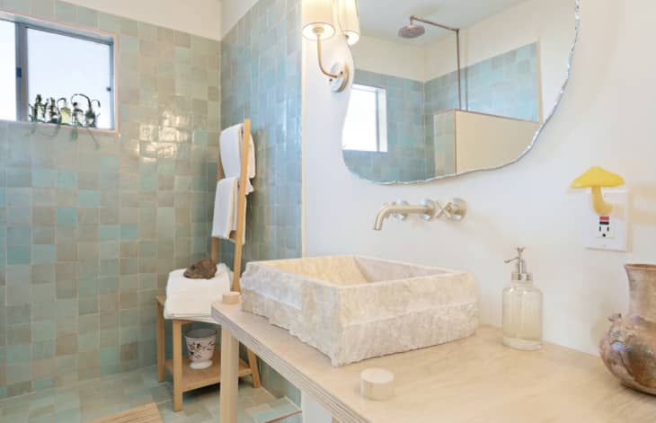 Elegant bathroom with teal square-shaped zellige tile in shower