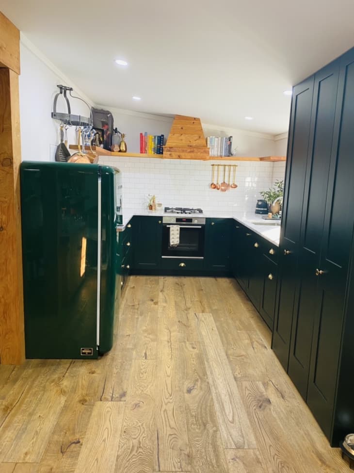 Kitchen with green cabinetry and green Smeg