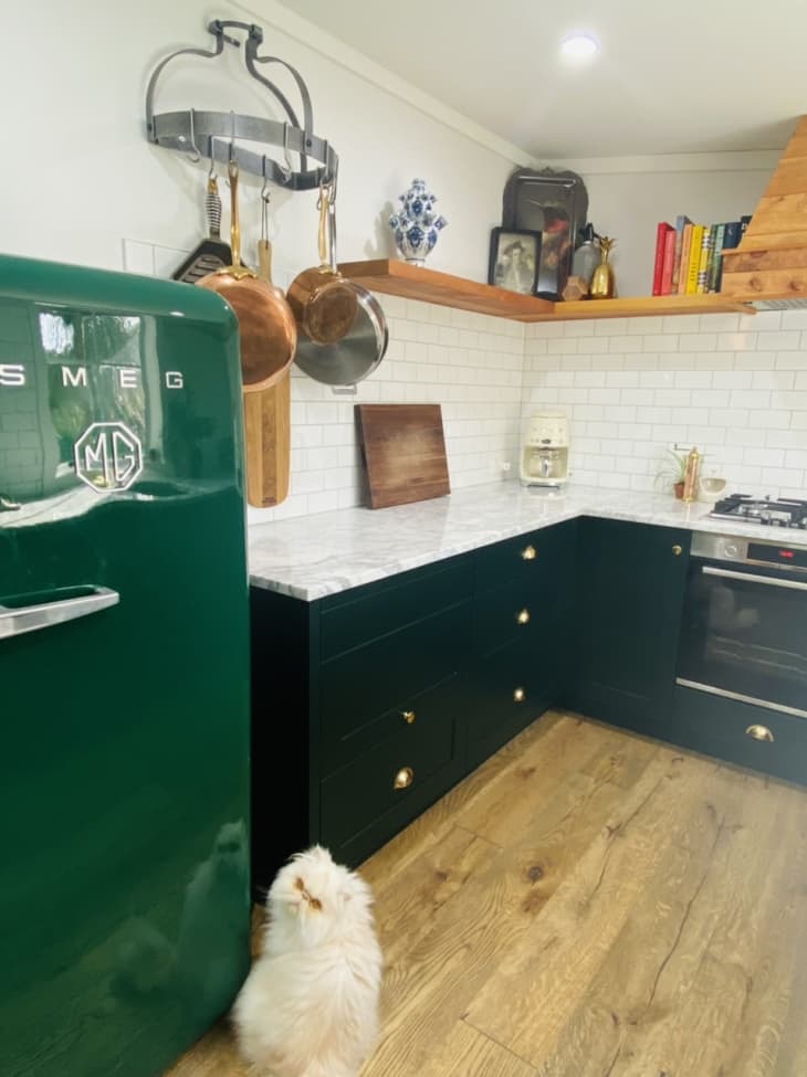 Kitchen with green lower cabinets and green Smeg