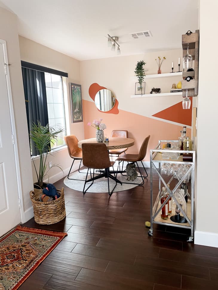 Dining room with peach and orange wall mural