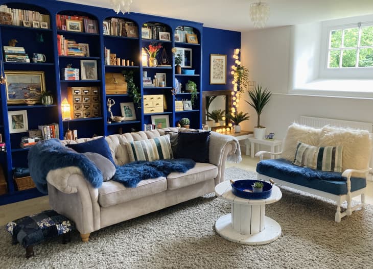 Living room with blue bookshelves along one wall