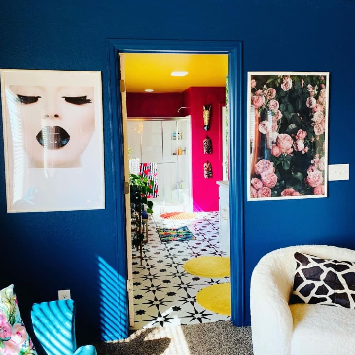 View of pink and yellow bathroom through navy doorframe
