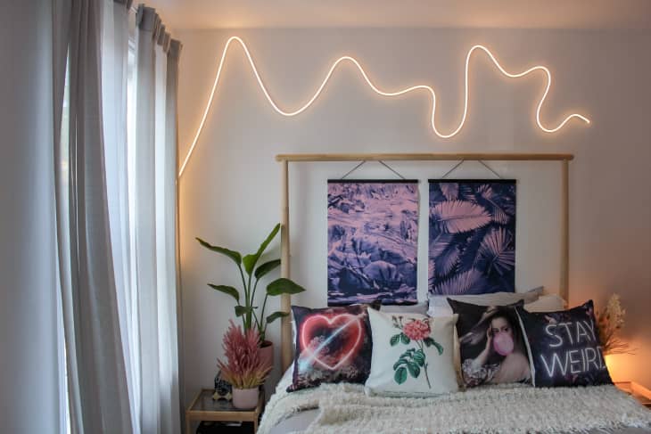 Bed with wavy neon light above