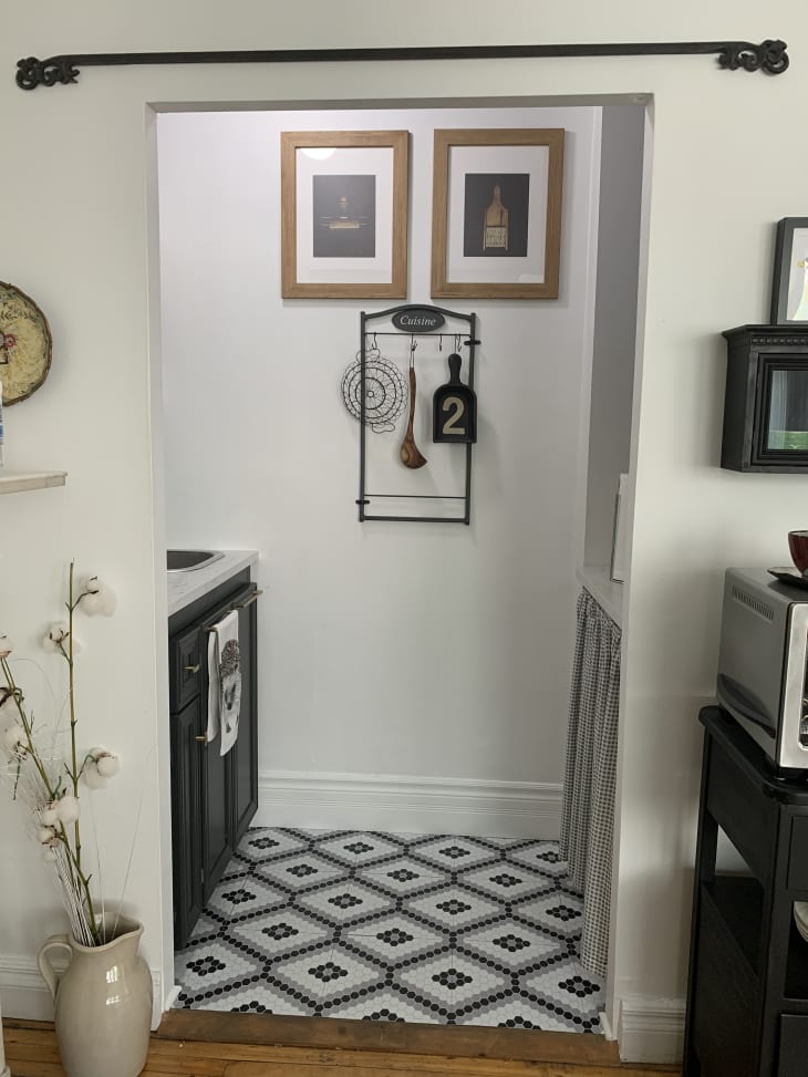 Small kitchen with black and white tile floors