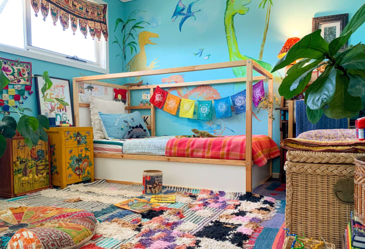 Colorful kid's room with dinosaur mural