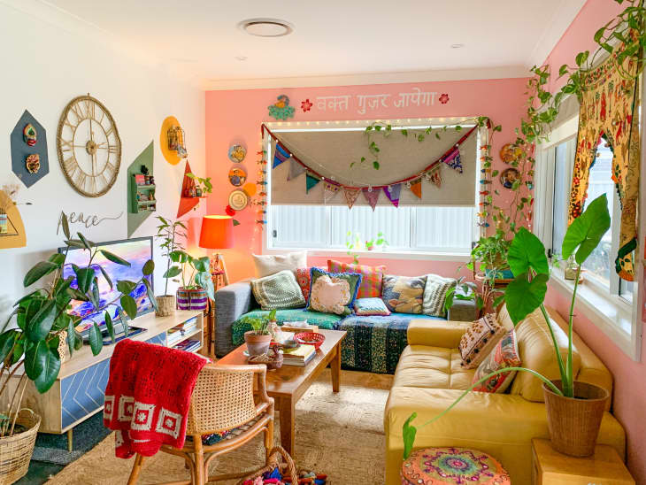 Extremely colorful living room with plants and pink accent walls