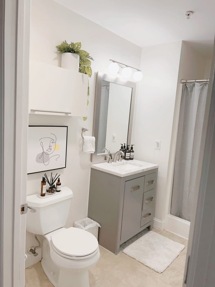 Mostly white bathroom with gray vanity