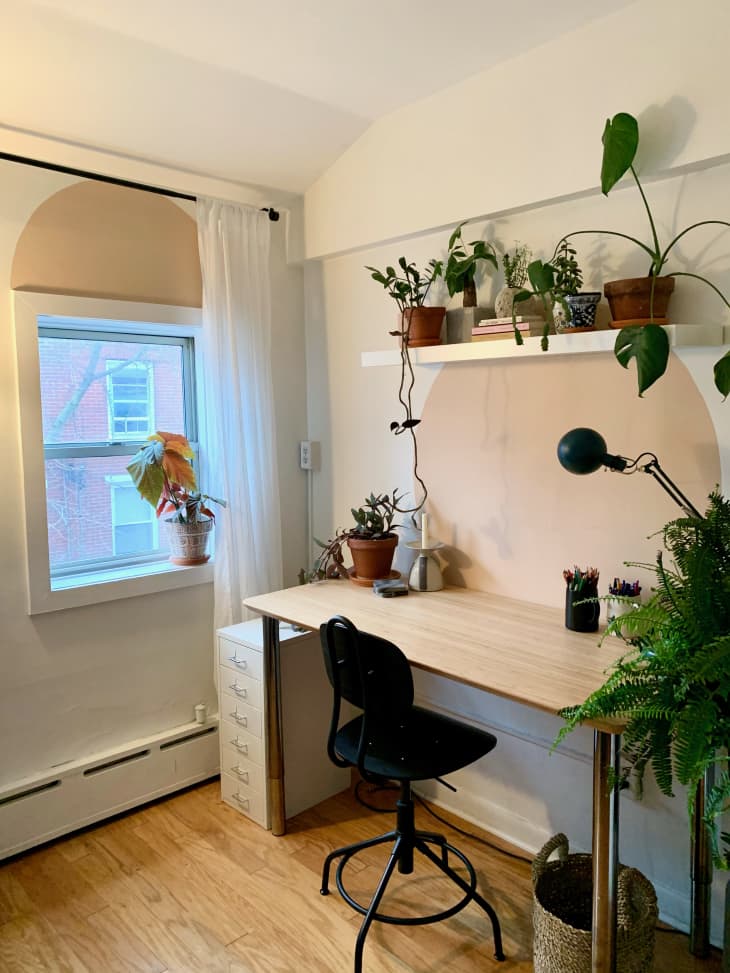 Desk surrounded by plants in guest bedroom