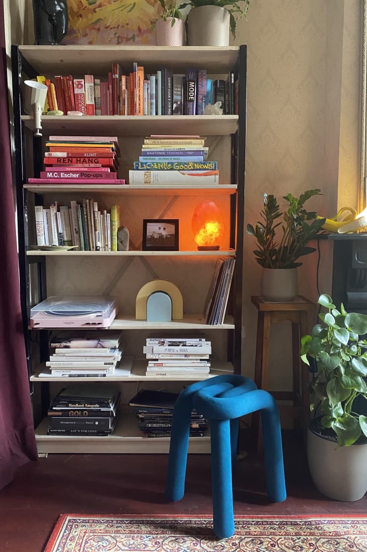 Bookshelf with blue stool in front of it