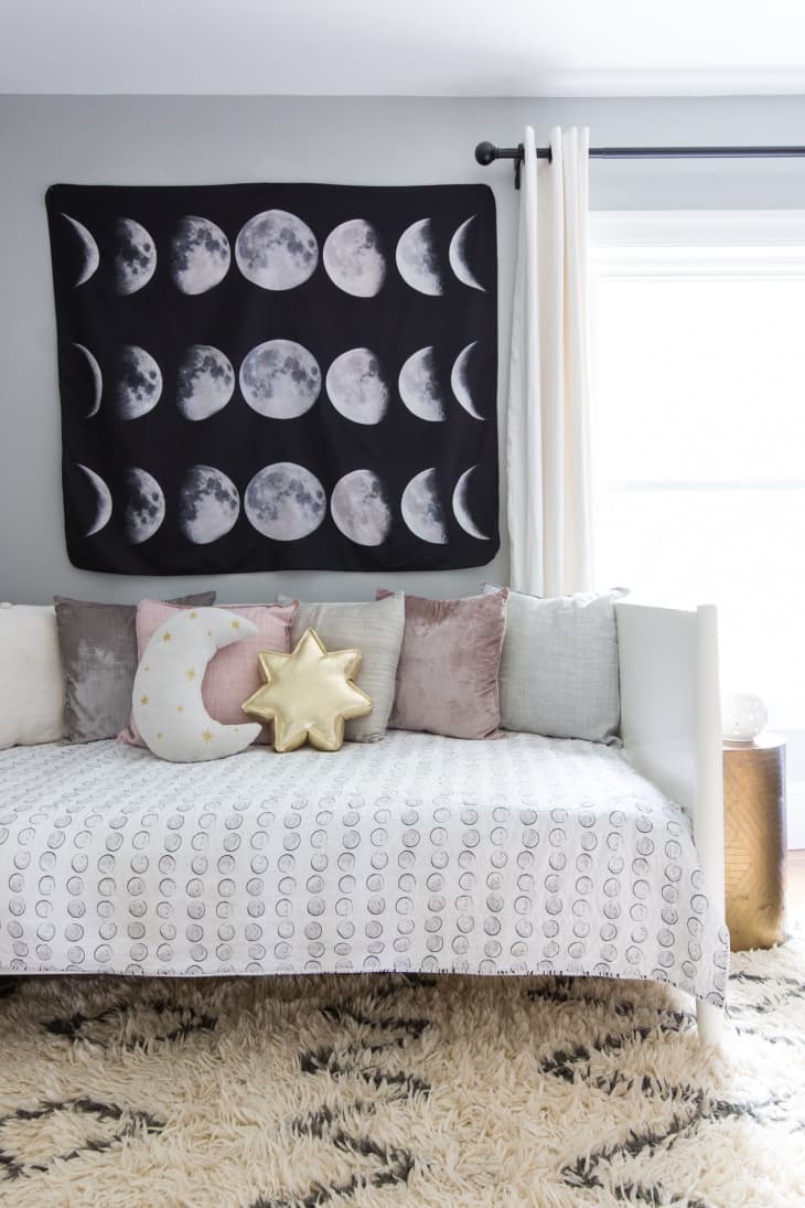 Daybed with moon tapestry above