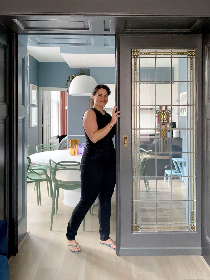 Woman standing next to french doors leading into dining room